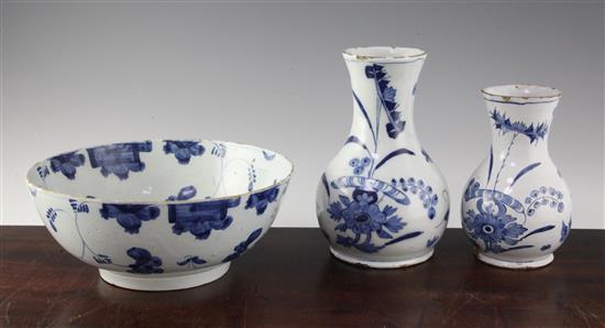 An English delft ware punch bowl and two graduated English delft ware baluster vases, second quarter 18th century,